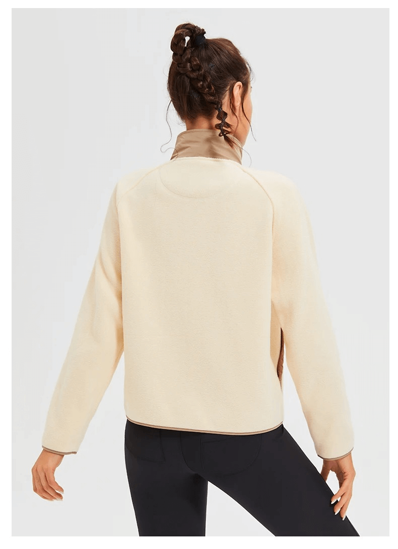 Back view of a woman wearing a stylish wool sports jacket with a mandarin collar, ideal for running. Windproof and anti-shrink design.